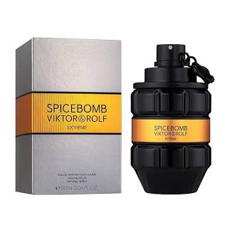 Viktor & Rolf Spicebomb Extreme perfume shown with its retail box and the bottle. The box is textured silver with a wide orange band, and the bottle is black with a matching orange band and a small black hanging loop.