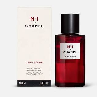 Chanel No. 1 L'Eau Rouge fragrance mist, showing the dark red glass bottle with a black cap next to its white cardboard packaging box.